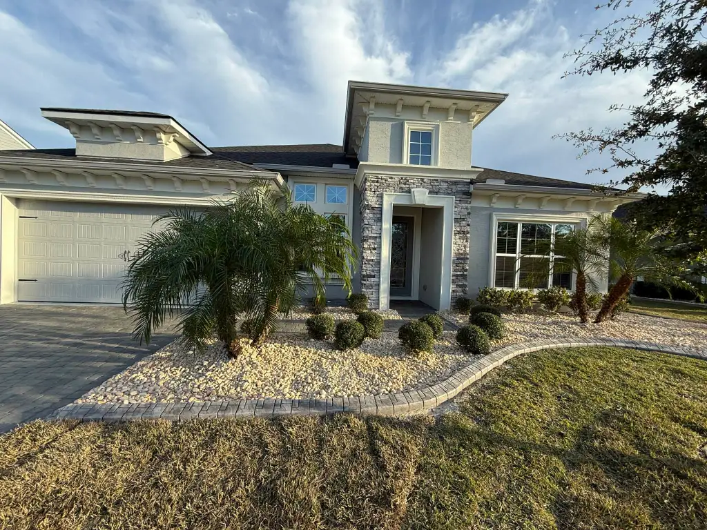 Light decorative rock landscape with rounded shrubs and palms