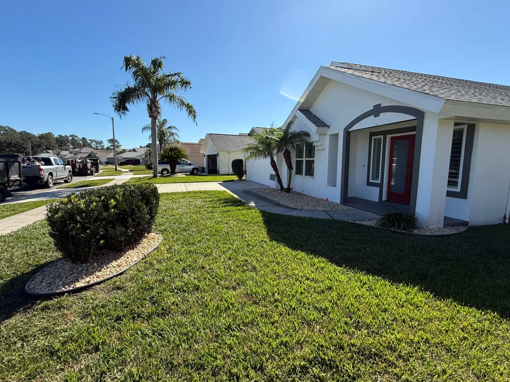 Completed front yard with light stone landscape beds